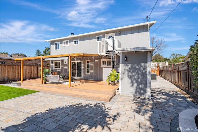 back of house with a deck, a patio area, and a fenced backyard