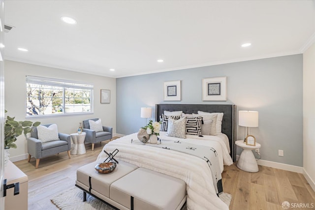 bedroom with ornamental molding, recessed lighting, baseboards, and light wood finished floors