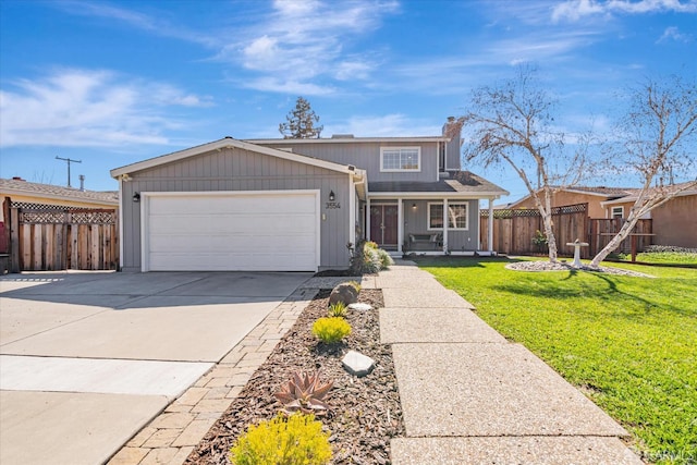 view of front facade featuring an attached garage, fence, driveway, and a front lawn