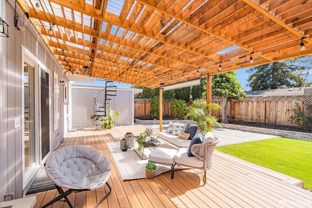 wooden deck with a fenced backyard and outdoor lounge area