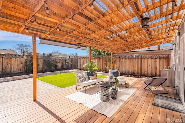 deck featuring a fenced backyard and a pergola