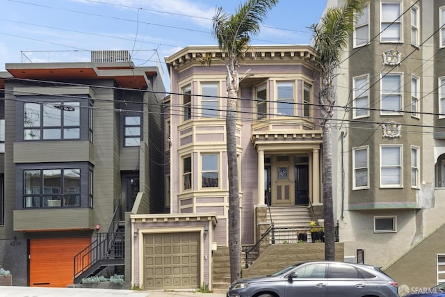 view of front of home featuring stairs and a garage