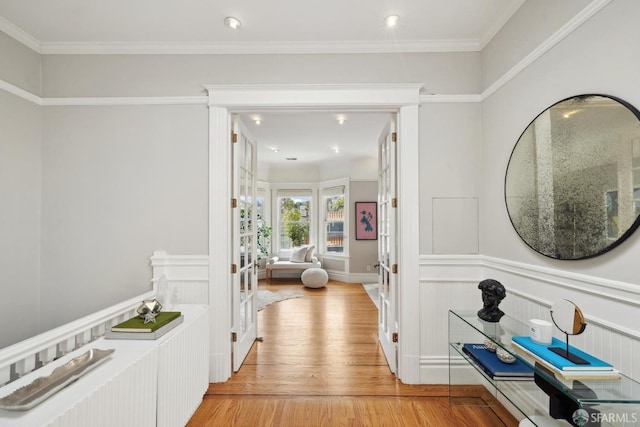 corridor with recessed lighting, wainscoting, and light wood finished floors