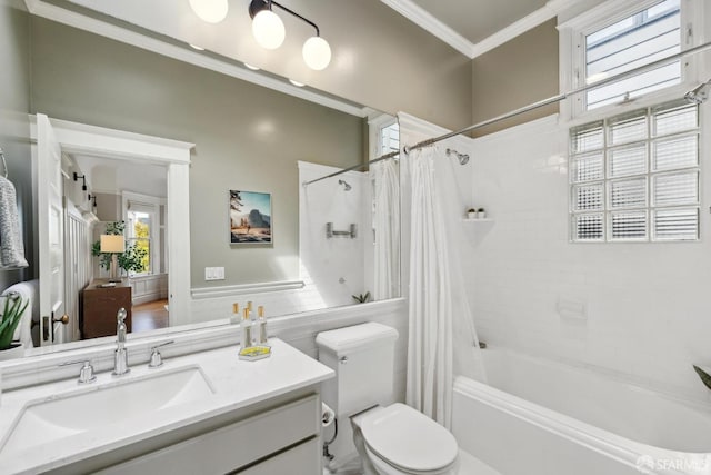 full bathroom featuring crown molding, vanity, wainscoting, toilet, and shower / tub combo
