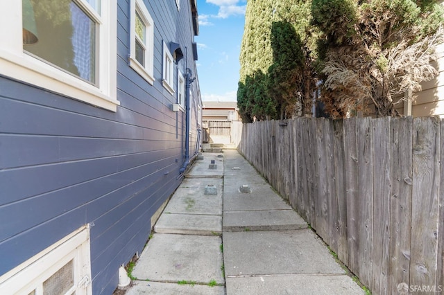 view of side of home featuring fence