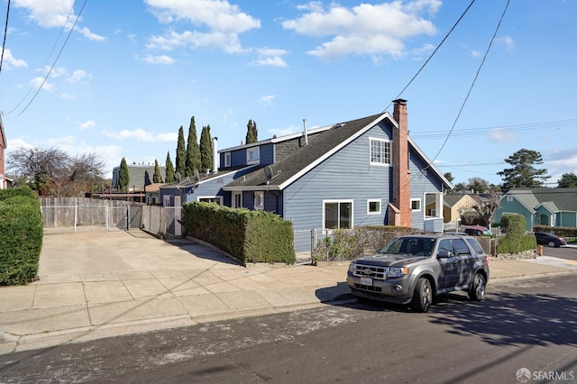 view of front of house featuring fence and a chimney