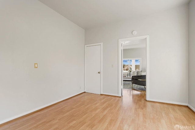 unfurnished room featuring light wood-type flooring and baseboards