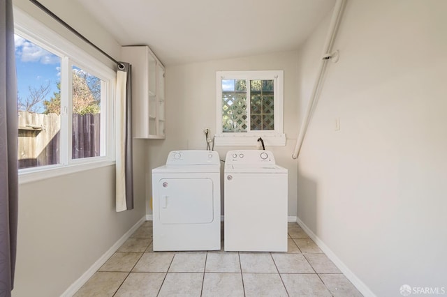 washroom featuring light tile patterned floors, independent washer and dryer, and baseboards