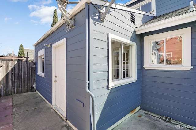 view of side of home featuring fence