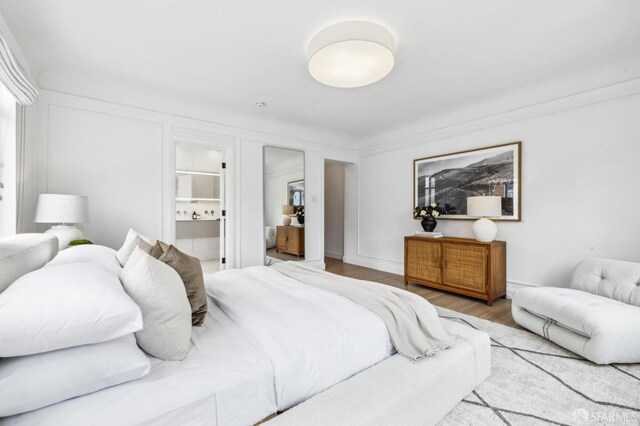 2100 Green St Unit 302, San Francisco, CA 94123 - bedroom with connected bathroom and wood finished floors