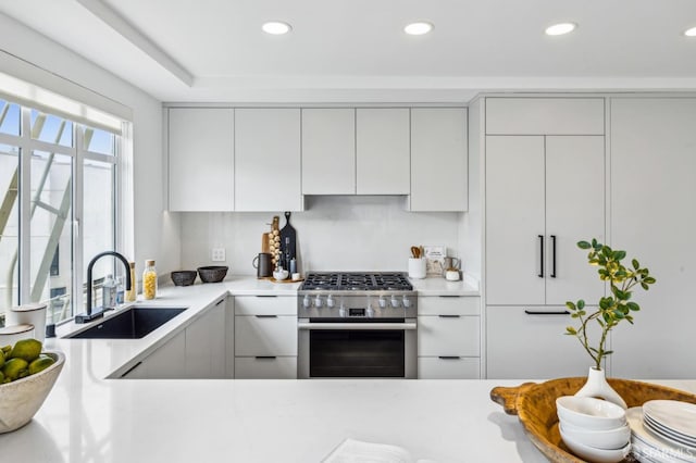 2100 Green St Unit 302, San Francisco, CA 94123 - kitchen featuring white cabinets, a sink, stainless steel range with gas stovetop, recessed lighting, and modern cabinets
