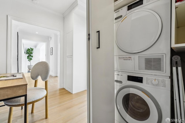 2100 Green St Unit 302, San Francisco, CA 94123 - laundry area with stacked washer and dryer, light wood-type flooring, and crown molding