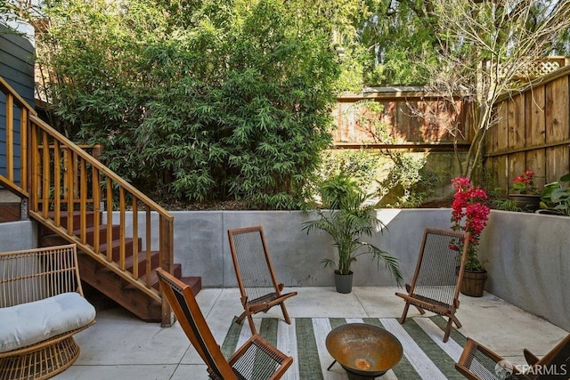 view of patio / terrace with stairs and fence