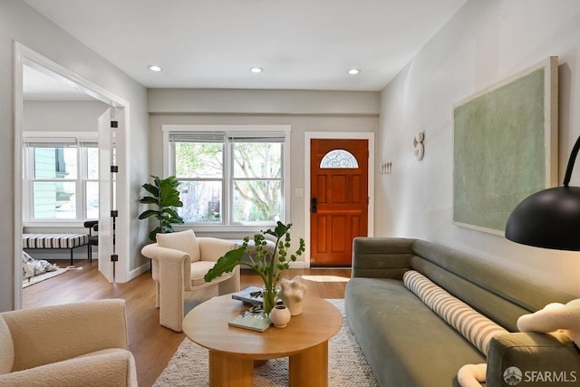 living area with plenty of natural light, light wood-style floors, and recessed lighting