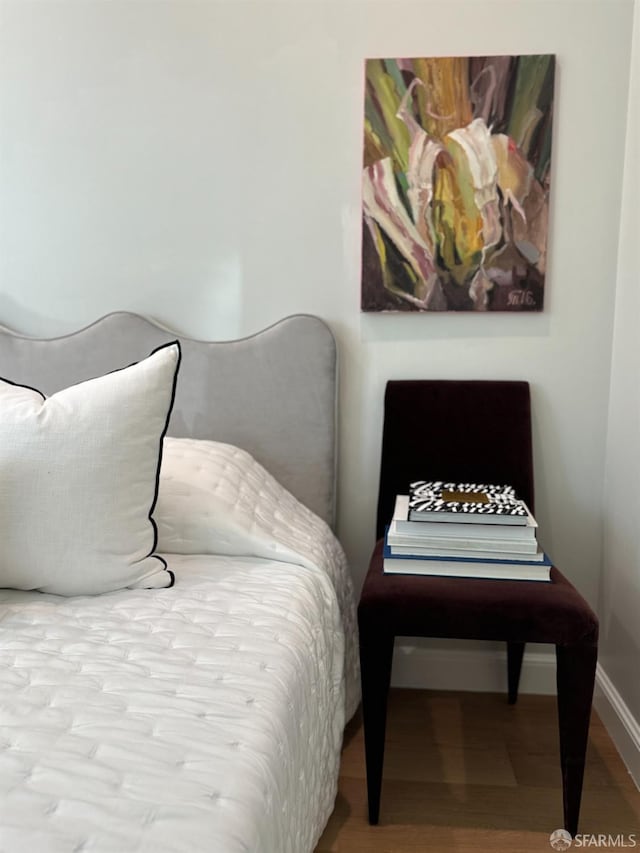 bedroom with baseboards and wood finished floors