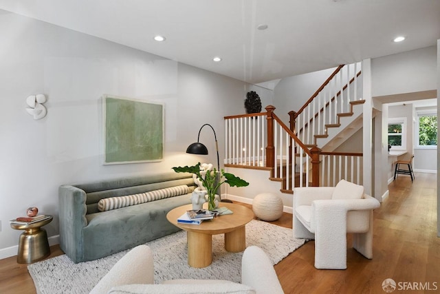 living room with stairs, recessed lighting, wood finished floors, and baseboards