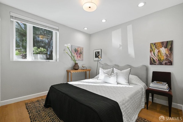 bedroom featuring recessed lighting, wood finished floors, and baseboards