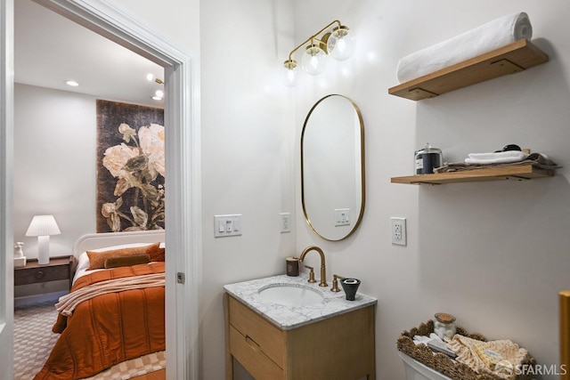 ensuite bathroom featuring connected bathroom and vanity