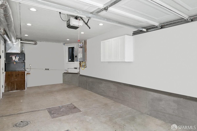 garage featuring recessed lighting, a garage door opener, and water heater