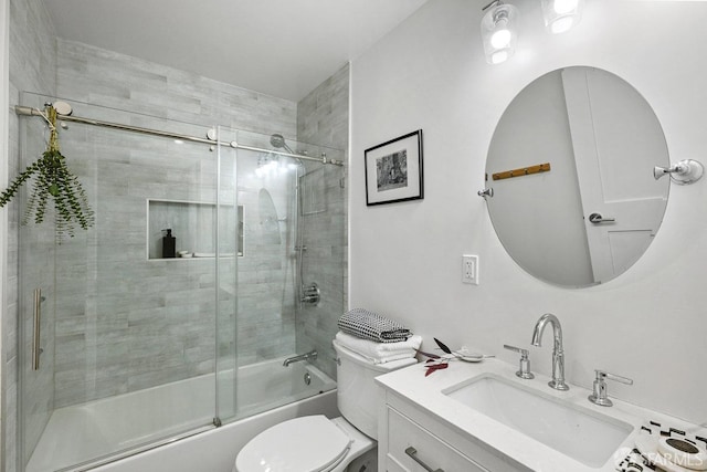 full bath featuring bath / shower combo with glass door, toilet, and vanity