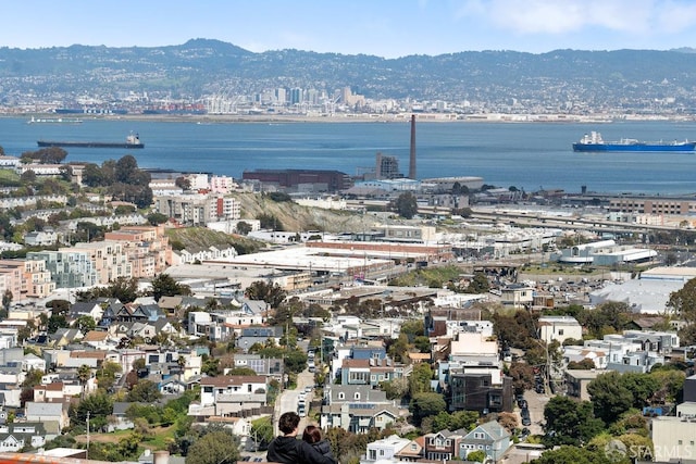 birds eye view of property featuring a water view and a view of city