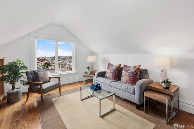 living room with hardwood / wood-style floors and lofted ceiling