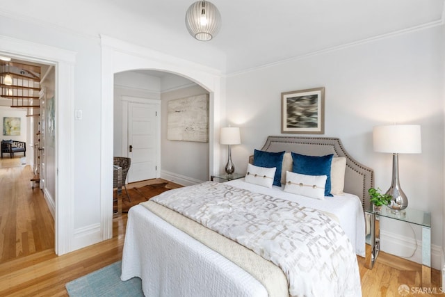 bedroom featuring hardwood / wood-style flooring and ornamental molding