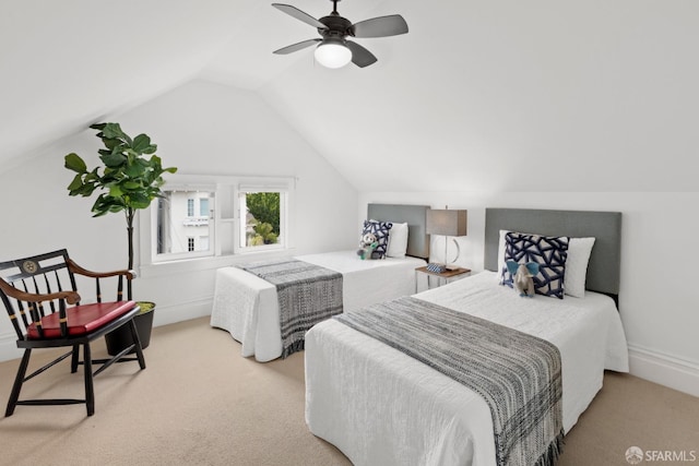 carpeted bedroom featuring ceiling fan and vaulted ceiling