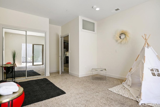 interior space featuring carpet, visible vents, and baseboards
