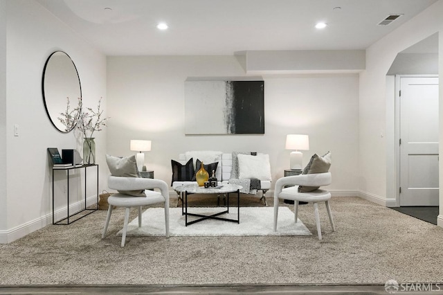 living room with recessed lighting, visible vents, and baseboards