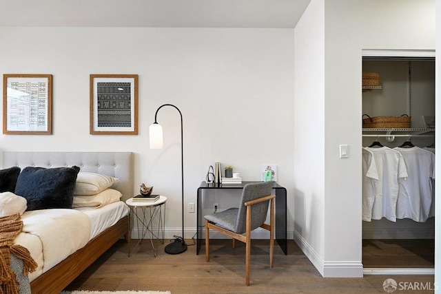 bedroom with baseboards and wood finished floors