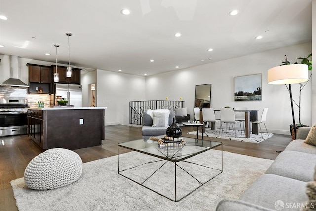 living room featuring baseboards, dark wood-style flooring, and recessed lighting