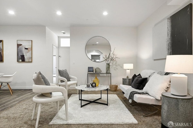 living room with baseboards, wood finished floors, and recessed lighting