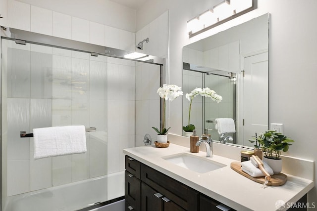 bathroom featuring vanity and bath / shower combo with glass door