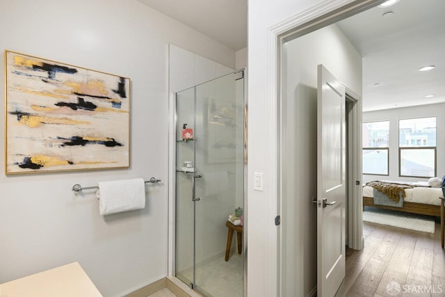 full bath with recessed lighting, wood finished floors, a stall shower, and ensuite bathroom