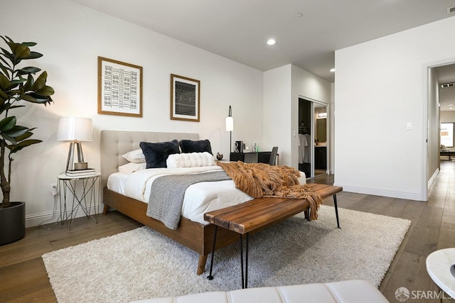 bedroom with baseboards, wood finished floors, visible vents, and recessed lighting