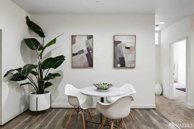 dining room with baseboards and dark wood-type flooring