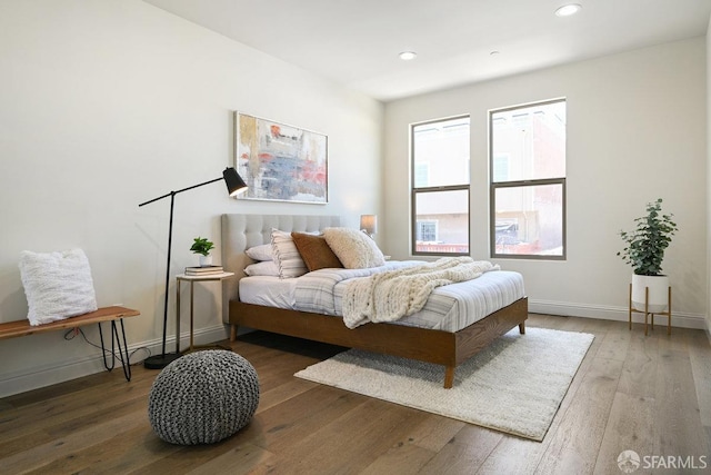 bedroom with baseboards, recessed lighting, and wood-type flooring