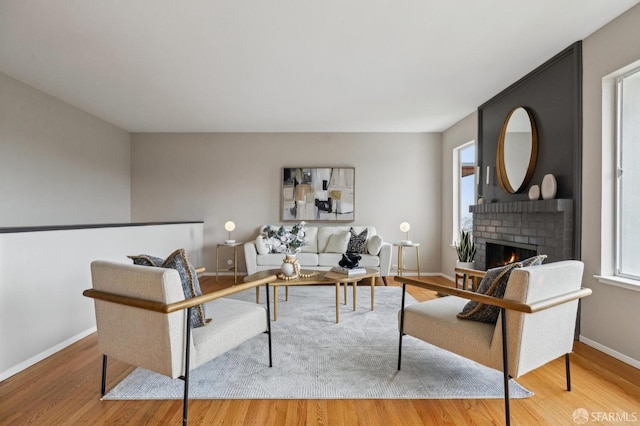 316 Gold Mine Dr, San Francisco, CA 94131 - living room with baseboards, wood finished floors, a wealth of natural light, and a brick fireplace