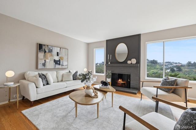 316 Gold Mine Dr, San Francisco, CA 94131 - living room featuring a brick fireplace, wood finished floors, and baseboards