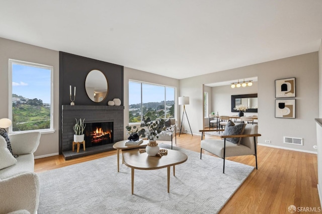316 Gold Mine Dr, San Francisco, CA 94131 - living room with visible vents, baseboards, light wood-style floors, and a fireplace