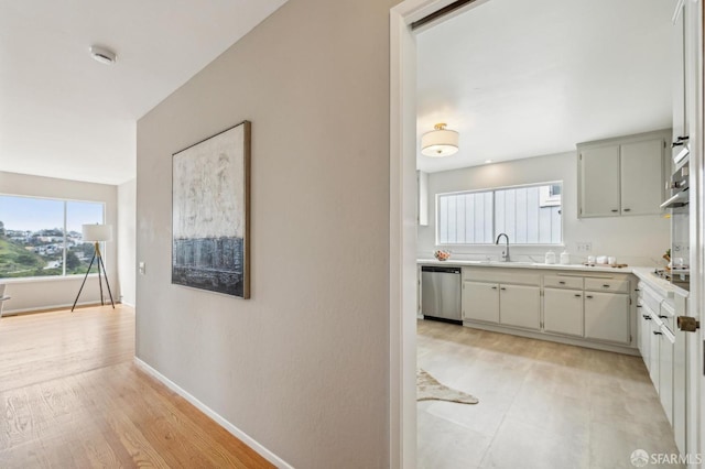 316 Gold Mine Dr, San Francisco, CA 94131 - hall featuring a sink, a healthy amount of sunlight, light wood-type flooring, and baseboards