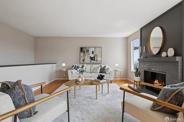 316 Gold Mine Dr, San Francisco, CA 94131 - living room with wood finished floors, baseboards, and a brick fireplace