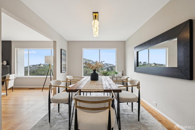 316 Gold Mine Dr, San Francisco, CA 94131 - dining room featuring baseboards, light wood-style floors, and a healthy amount of sunlight