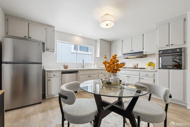 316 Gold Mine Dr, San Francisco, CA 94131 - kitchen with a sink, stainless steel appliances, light wood-style floors, under cabinet range hood, and light countertops