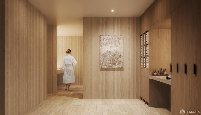 interior space featuring tile patterned flooring and wooden walls