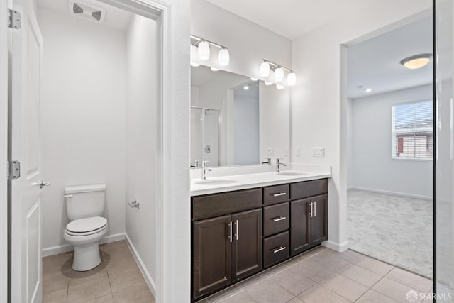 bathroom with tile patterned floors, vanity, and toilet