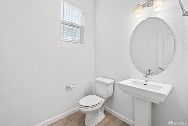 bathroom with tile patterned floors and toilet