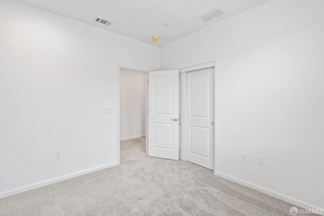 unfurnished bedroom featuring light colored carpet