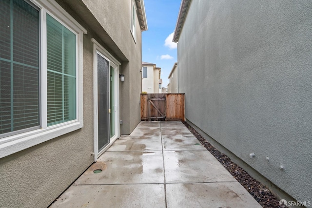 view of property exterior with a patio area